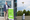 Dan O’Toole stands next to an Arrive AI smart mailbox. Beside him, a drone delivers a package into another smart mailbox in an outdoor demo of autonomous delivery.